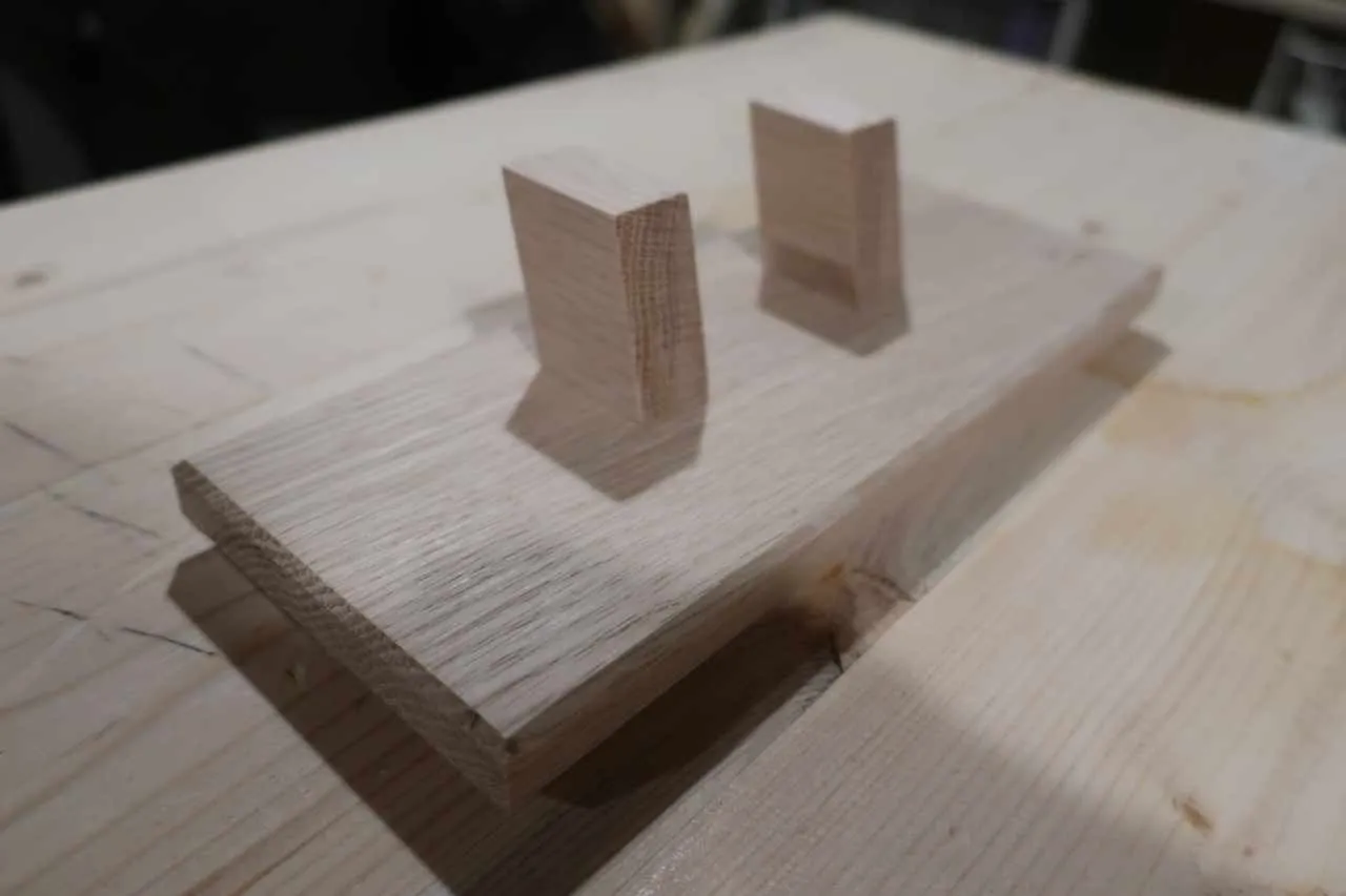 Added a bevel on the underside of the bottom piece, and a smaller bevel on the top side. Glued the supports to the bottom piece. Also did some sanding.